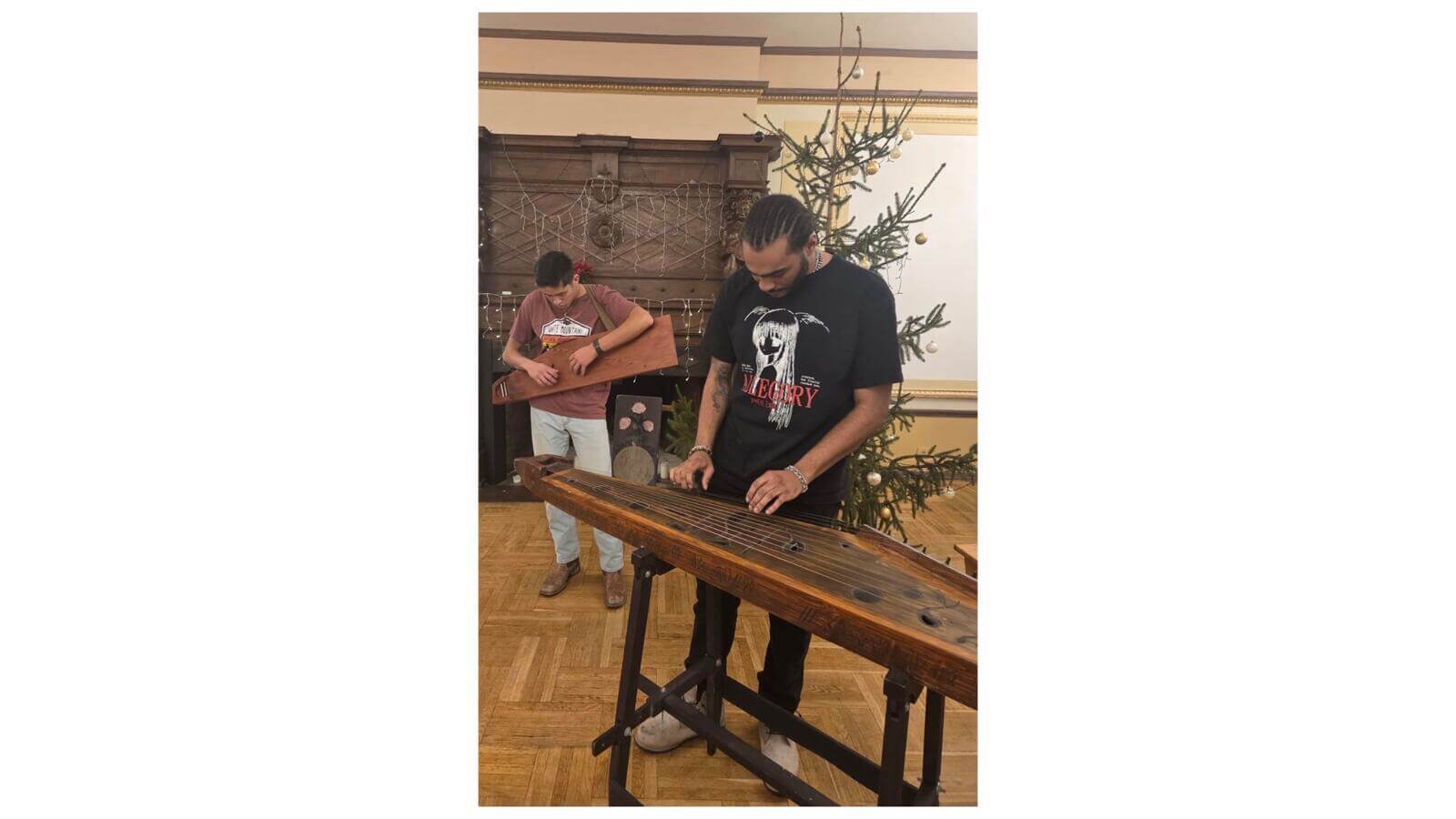 Russian minor Rahmel DeSoto, ’27, playing the kokle, a Latvian folk instrument, in Riga